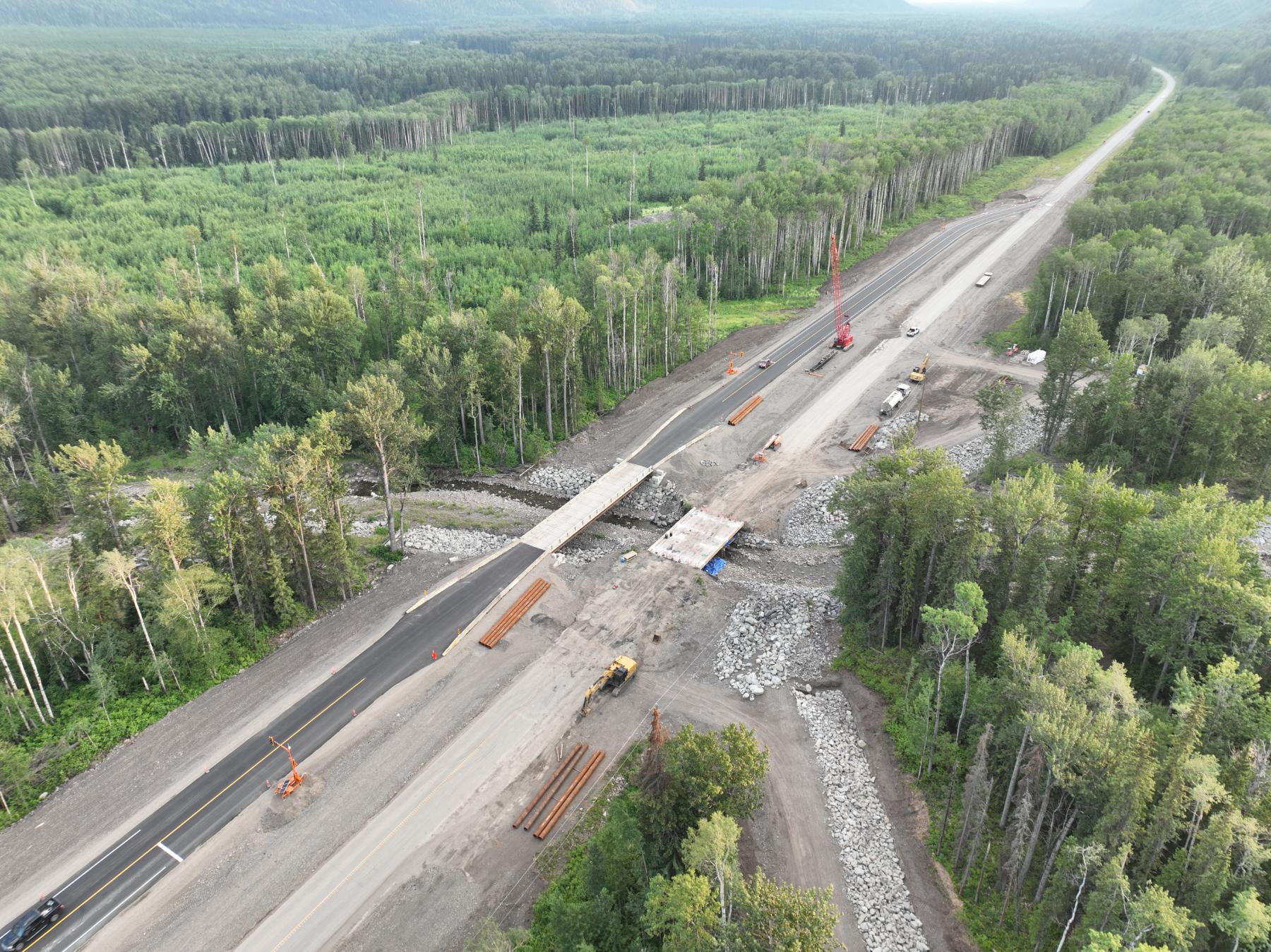 Aerial view of a highway realignment and creek crossing under construction